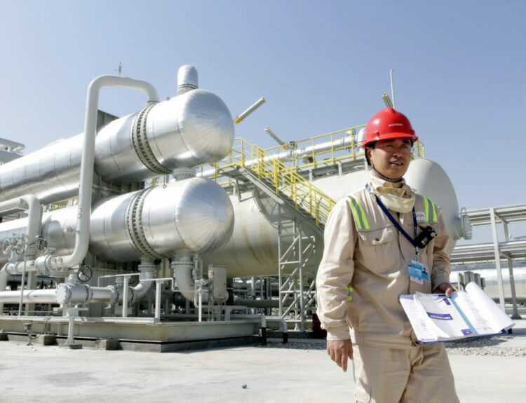 A Chinese oil worker stands at al-Halfaya refinery in Amara, © EPA/STR
